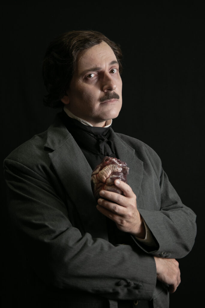 Campbell Harmon as Edgar Allan Poe holding the Tell-Tale Heart